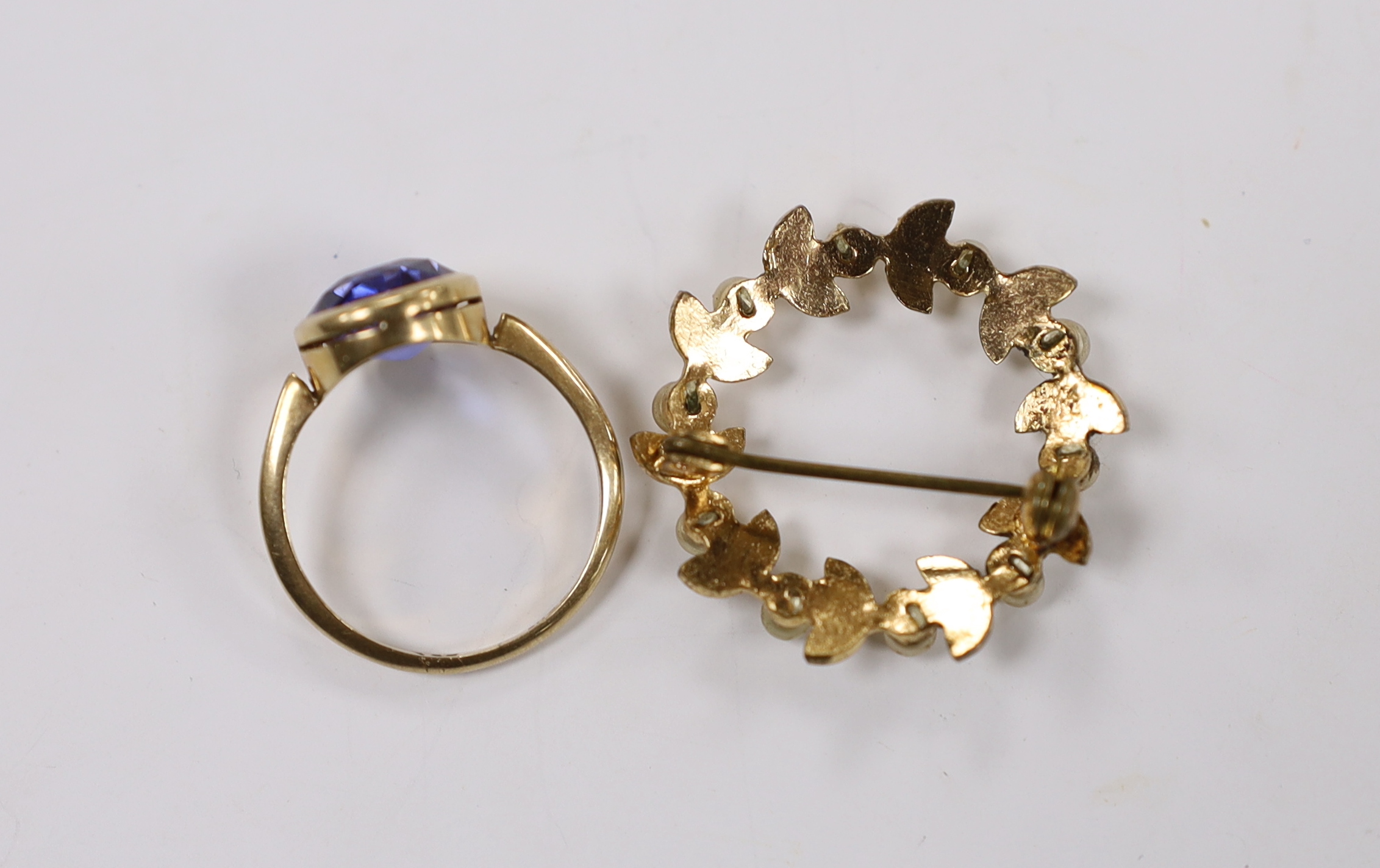 A 9ct and oval cut synthetic sapphire set ring, size P/Q, together with a costume brooch.